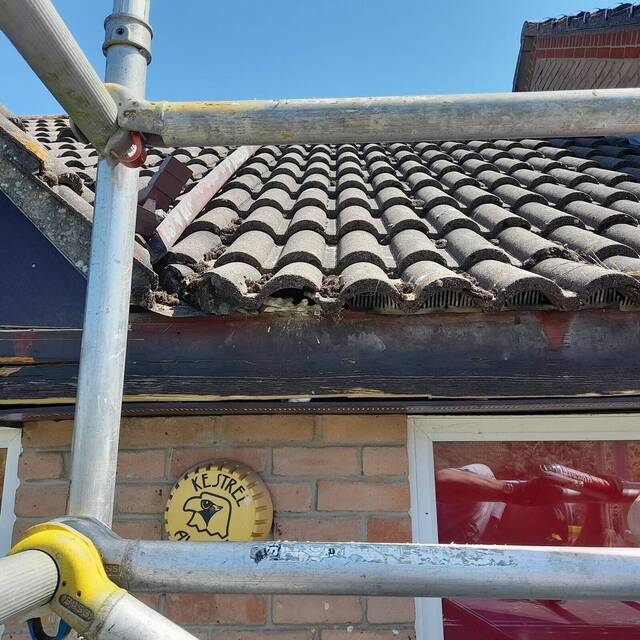 During: old fascia exposed along the roofline