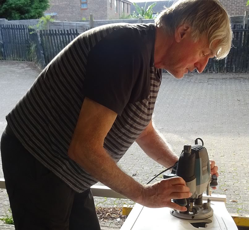 Richard Cordrey shaping a workpiece with a router